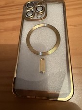 case with a gold-colored frame and a built-in magnetic ring iPhone 16 Pro Max