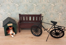 Dolls house dog in kennel, bicycle and garden bench