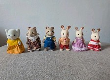 Sylvanian Families figure bundle including 2 racoons, 3 rabbits & 1 elephant