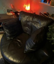 Leather swivel cuddle chair.