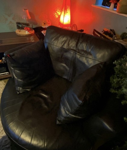 Leather swivel cuddle chair.