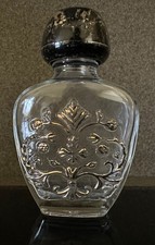 Vintage glass perfume bottle with decorative relief design