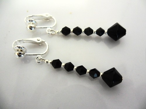 Pair dangly black glass - a, of