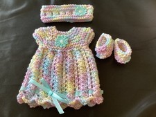 Hand knitted dolls clothes to