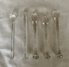 Four antique glass sugar crushers/ swizzle sticks + one unusual glass spoon