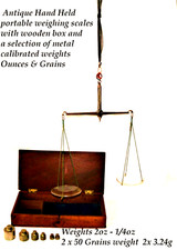 Antique portable handheld weighing scales with calibrated weights in wooden case