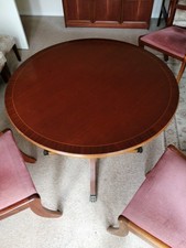 Circular pedestal dining table and four chairs