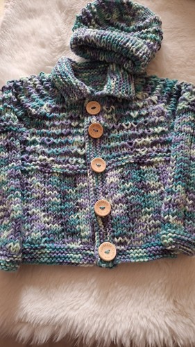 Hand knitted baby jacket and - hand,