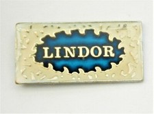 A771:) Enamel Blue Lindor Chocolate Confectionery Advertising Badge lapel 