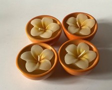 Flower Shaped Candles In Mini Orange Pots.
