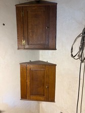 Apair of oak wall hung oak corner cupboards
