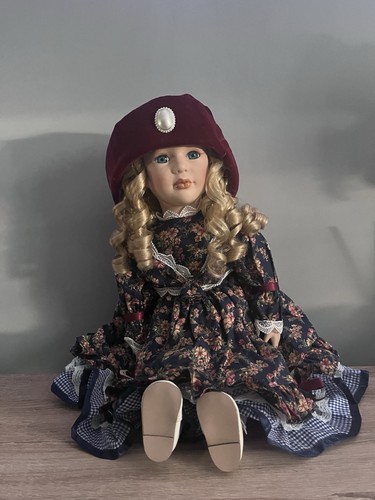 Seated porcelain doll - seated,