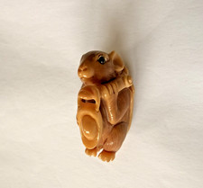Resin  carving of rat carrying scrolls or bamboo tubes depicting wealth