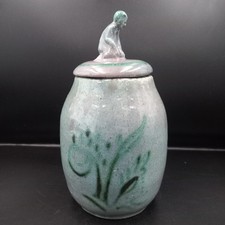 unusual pottery lidded jar figural kneeling man handle 23cm