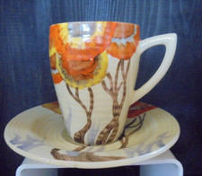 A Clarice Cliff Lynton shape coffee cup & saucer in RHODANTHE pattern.
