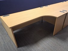 Light oak 1800mm by 1200mm radial desks with matching mobile pedestals