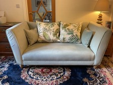 sofa and matching chair on turned wooden feet and complete with matching cushion