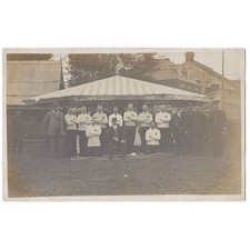 SOCIAL HISTORY Tug O War Team in front of Fairground Stall, RP Postcard Unused