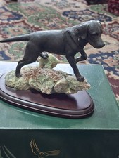 BLACK LABRADOR ON ROCK BASE BY