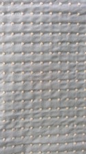 Pale green upholstery fabric with cream stitched spots