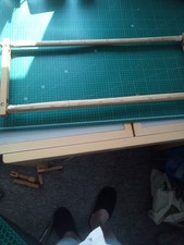 Wooden tapestry frame with webbing.75x27cms the tapestry bar is 69cms long