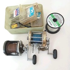 Two Multiplier Sea reels by Daiwa plus a collection of hooks and lures.