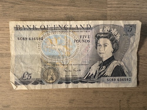 Old paper note featuring - paper, £5