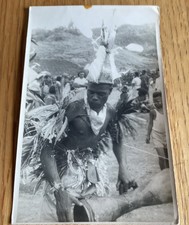 PAPAU NEW GUINEA TRIBESMAN IN TRIBAL HEADDRESS  PLAYING THE KUNDU DRUM c1950