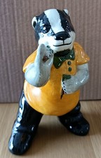 Dart playing badger figurine