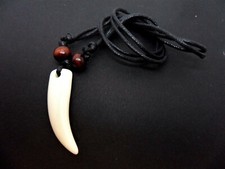 A  BLACK CORD TRIBAL TOOTH