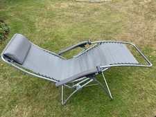 Two Lafuma Zero Gravity Reclining chairs with headrests, grey with carry bags.