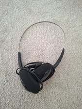 Supra-aural headphones with a thin metal headband and black earcups.