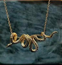 Golden coiled snake necklace, jewellery.  Coiled serpent around a gold chain