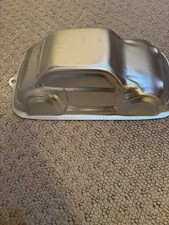 NOVELTY CAKE TIN CAR SHAPE 30cm LONG 10cm DEEP . USED TWICE NO MARKS