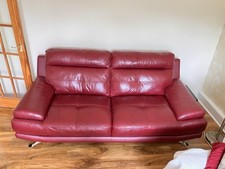 Very comfortable leather three seater sofa - maroon.