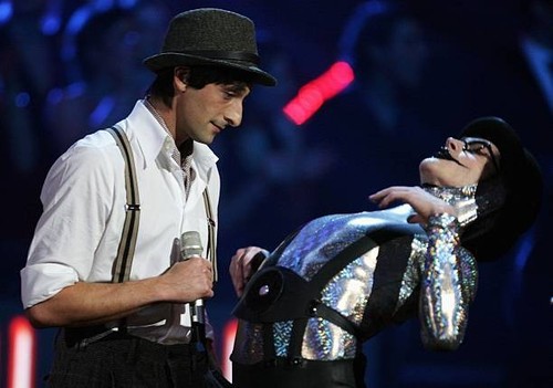 Adrien brody stands stage - on,