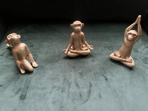 Trio monkey sculptures in - of,