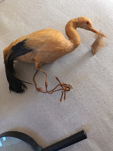 Antique stork carrying baby