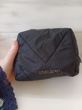 Victoria's Secret black makeup bag with a gold zip. Used