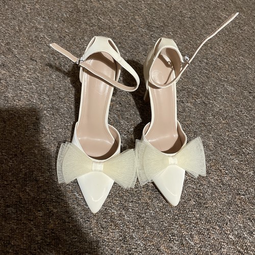 White bowed high heeled - high, shoe