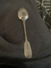 antique silver spoon featuring