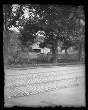 Wooden barn and other outbuildings seen from street with tro- New York Old Photo