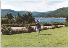 Cape Breton Piper at Keltic Lodge with Ingonish Beach Postcard