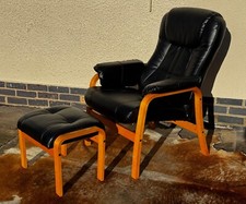 A single Danish reclining armchair and footstool Black Vinyl vegan