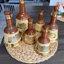 Large selection of vintage Bells Whisky Bottle Bell