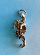 VINTAGE MERMAID SITTING ON A