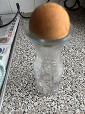 Four Glass Bottles With The Top To Store Small Little Things