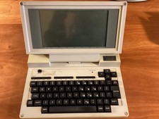TRS 80 (Tandy) Model 200, cream body in black leatherette bag, manufactured 1985