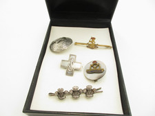 5 ASSORTED MILITARY STYLE BROOCHES, ALL DIFFERENT IN SIZE,SHAPE, AND STYLE.