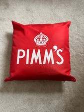 Pimms cushion in bright red with white writing 
